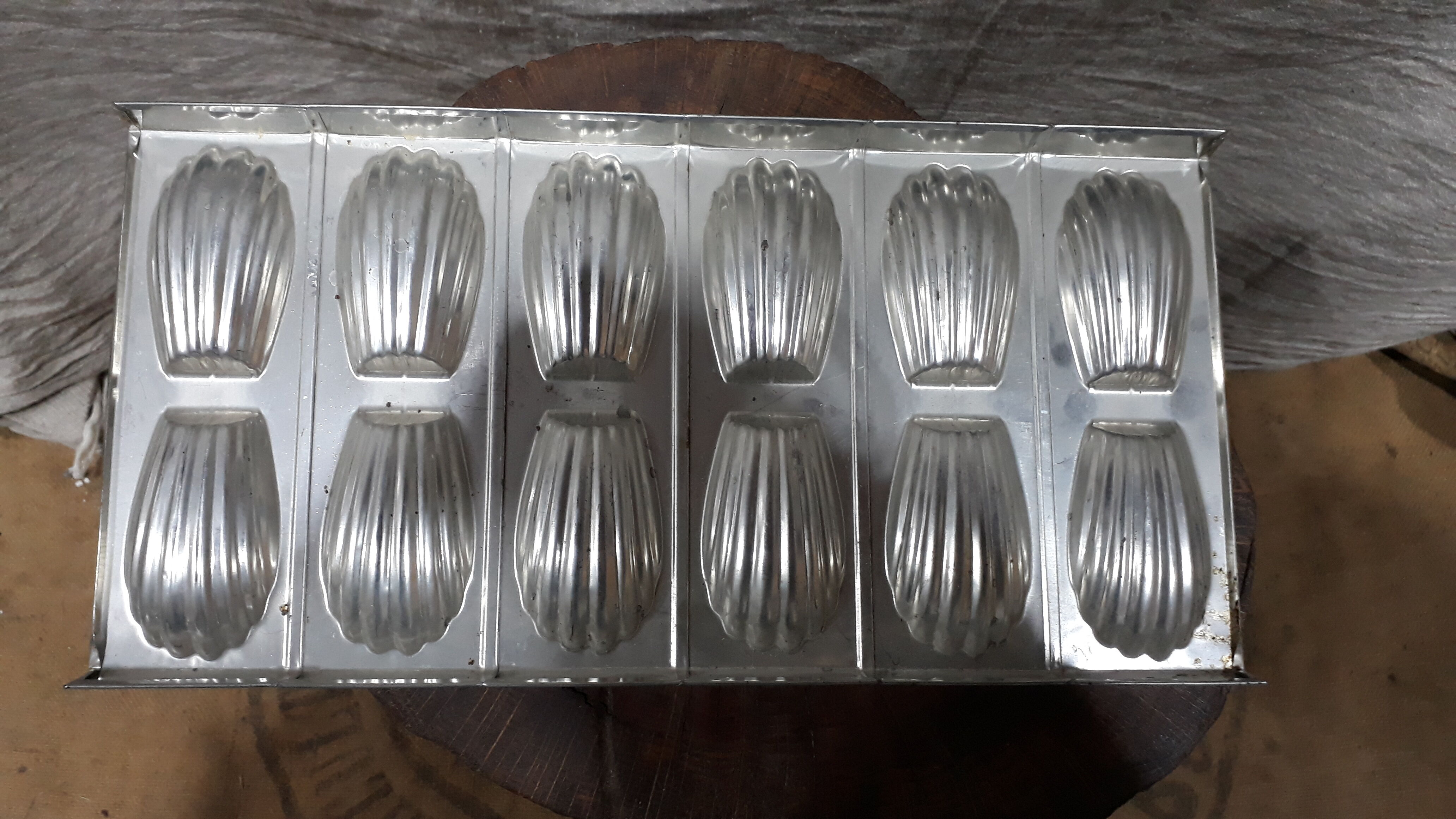 Old plate molded to madeleines