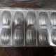 Old plate molded to madeleines