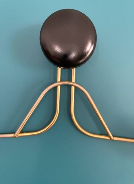 Golden brass coat rack with 3 black vintage hooks from the Mid Century 1950-60.