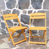 Pair of folding chairs in blond wood
