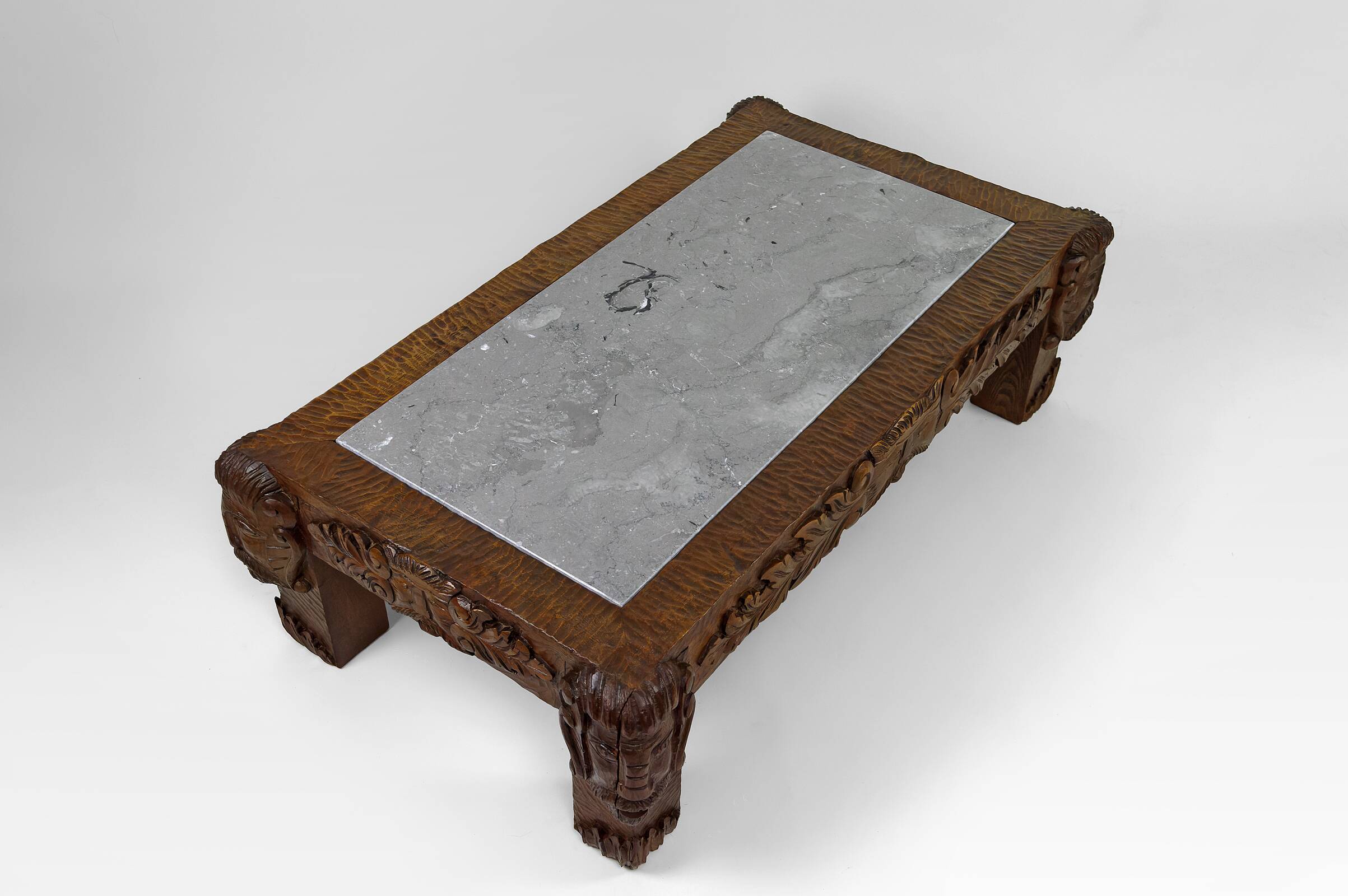 Solid oak coffee table carved with fauns and gray marble top, France, circa 1940