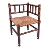 Old corner straw armchair in turned wood