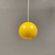 Spherical pendant lamp in sunny yellow.