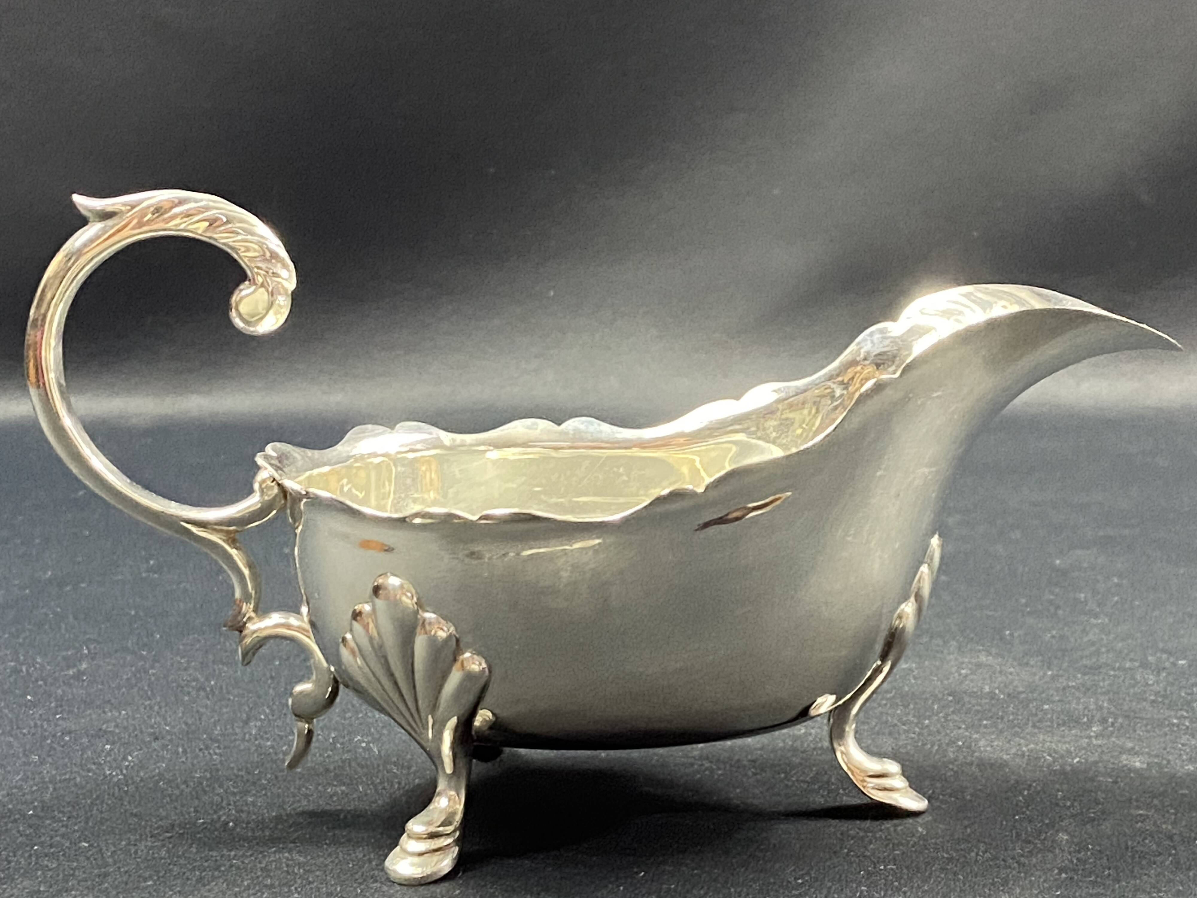 English George III style silver plated tripod sauce boat