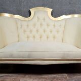 Banquette vintage à dossier capitonné, revêtu d’un tissu ivoire