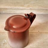 Old pitcher in brown enamelled sheet metal, spout and lid