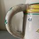 Old ceramic pitcher (18th century?) decorated with polychrome exotic birds