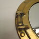 Mirror integrated into a brass navy porthole