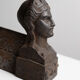 Pair of ancient cast iron chenets adorned with bust of Marianne