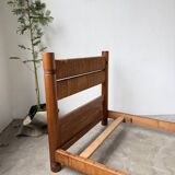 Brutalist style bed with chain and straw