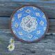 Decorative plate in blue enameled metal with bird motifs