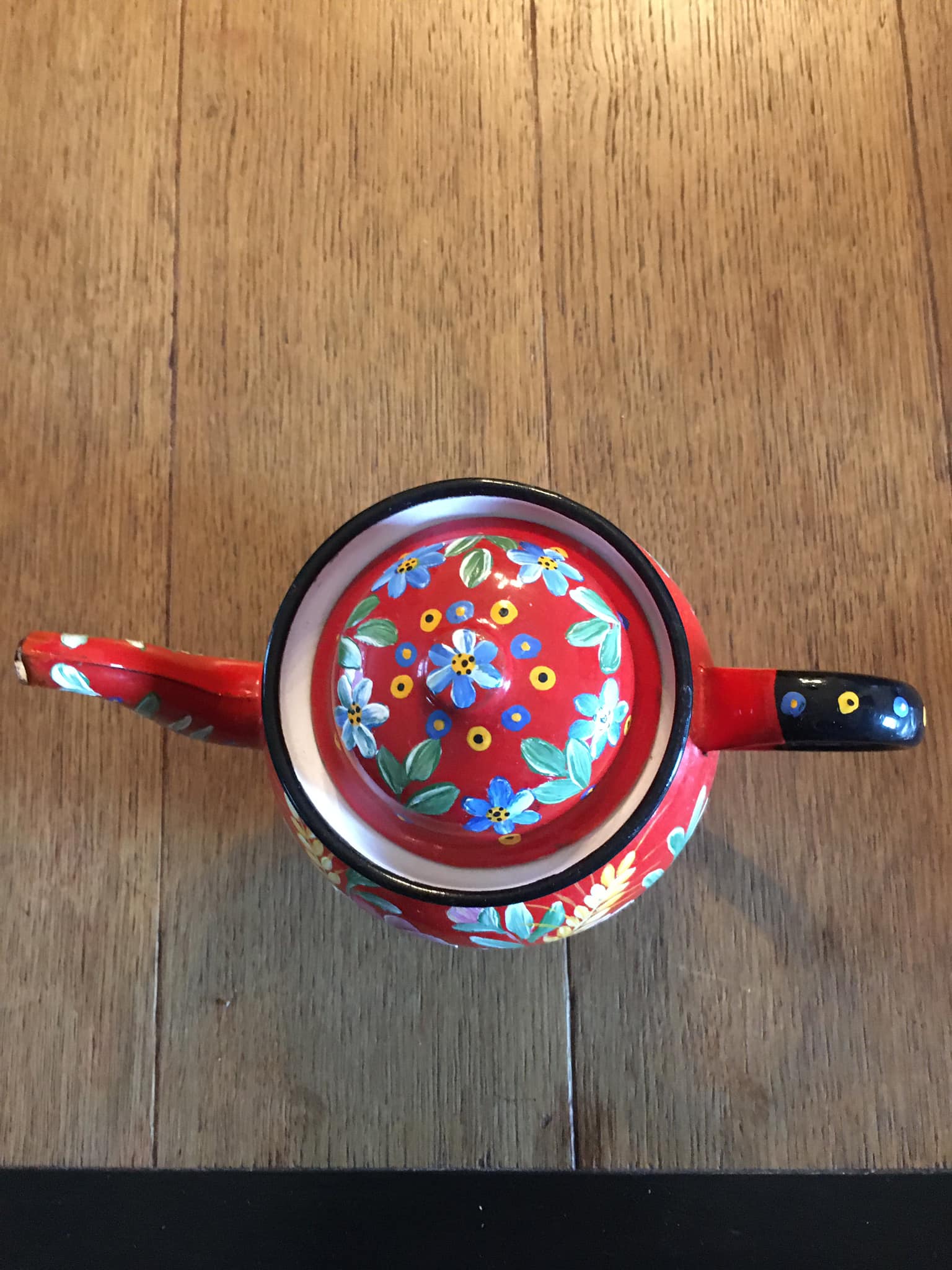 Red enamel teapot with hand-painted floral decoration