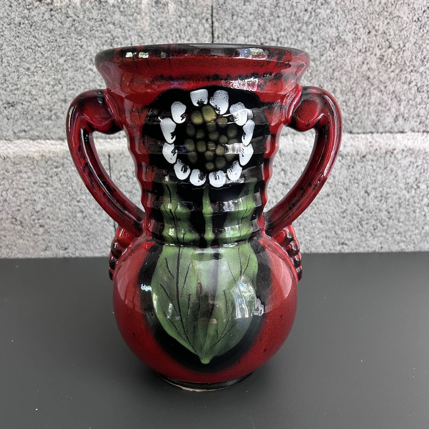 Red vase with floral decoration