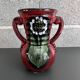 Red vase with floral decoration