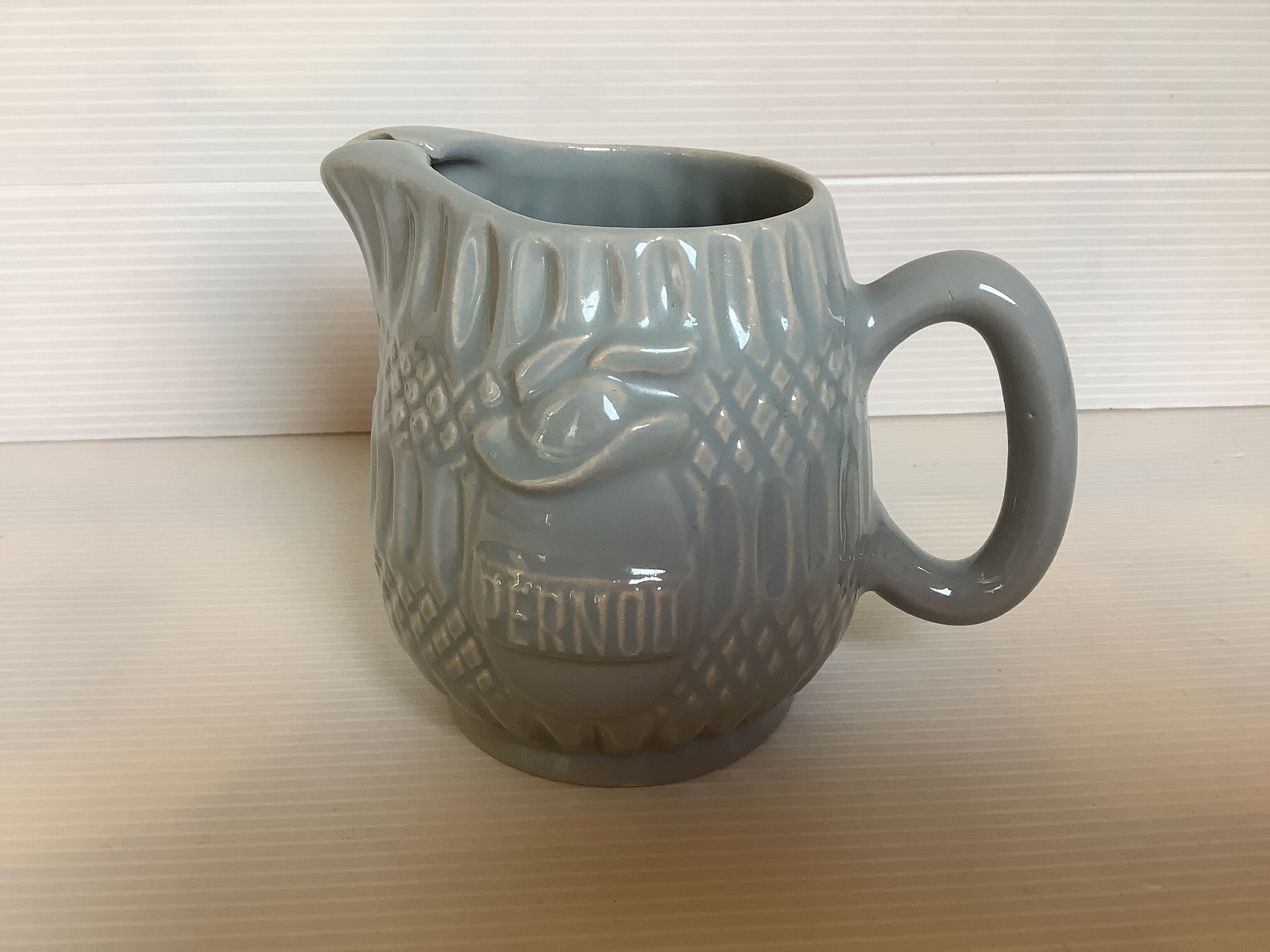 Old grey earthenware Pernod jug