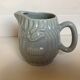 Old grey earthenware Pernod jug