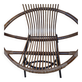 Shell-shaped armchair in rattan with metal legs. Caravane brand.