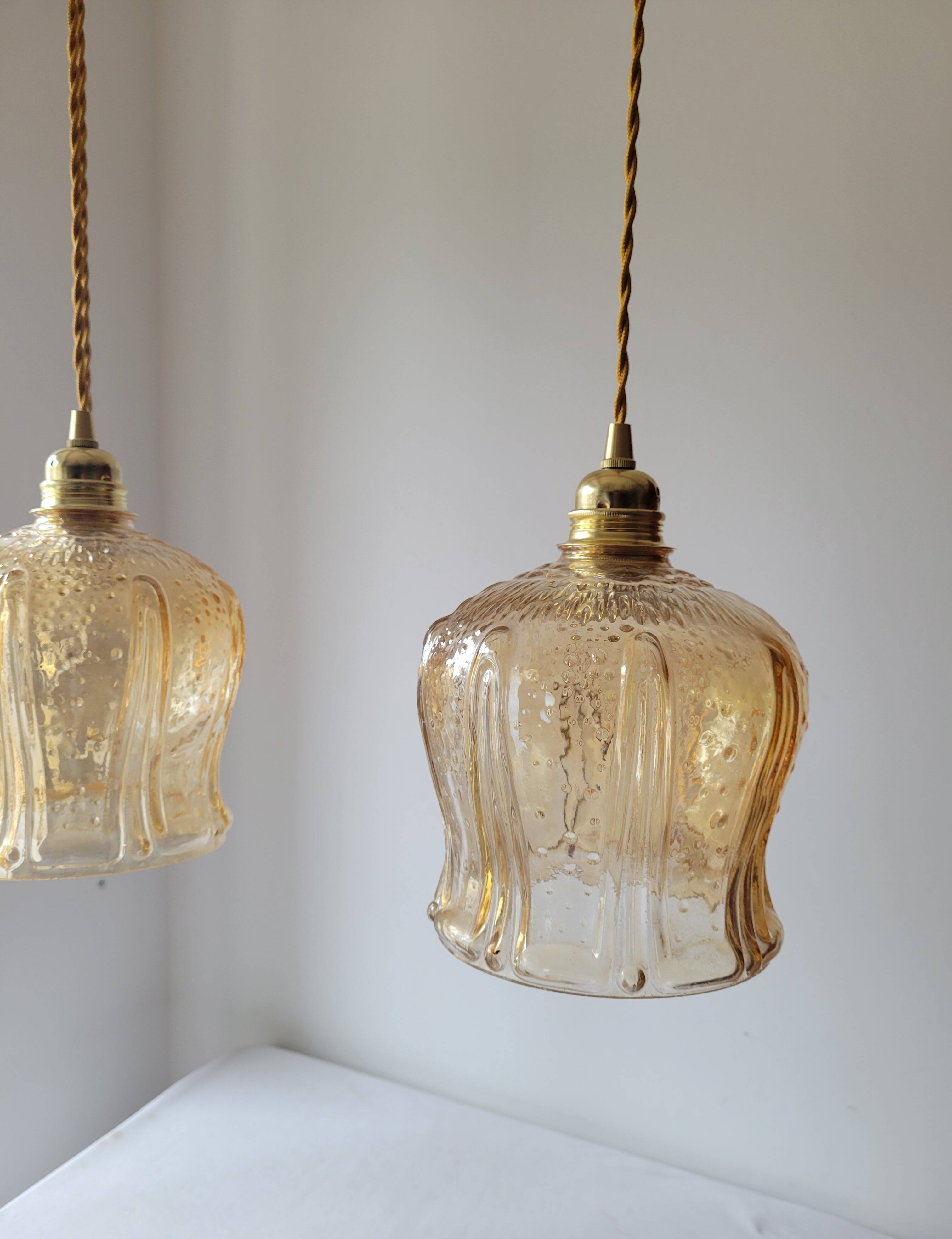 Trio of amber glass pendant lights