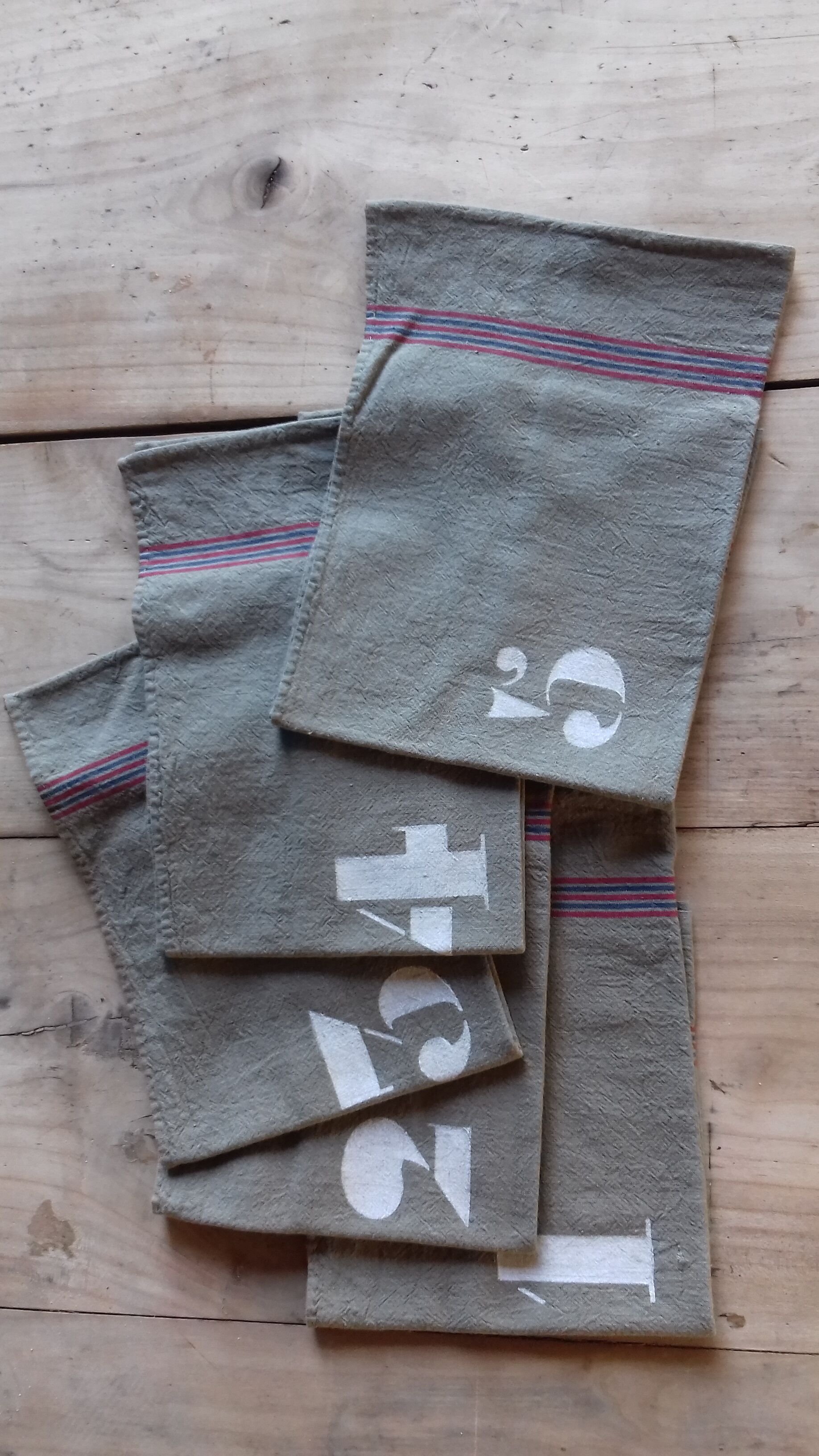 10 numbered khaki tea towels