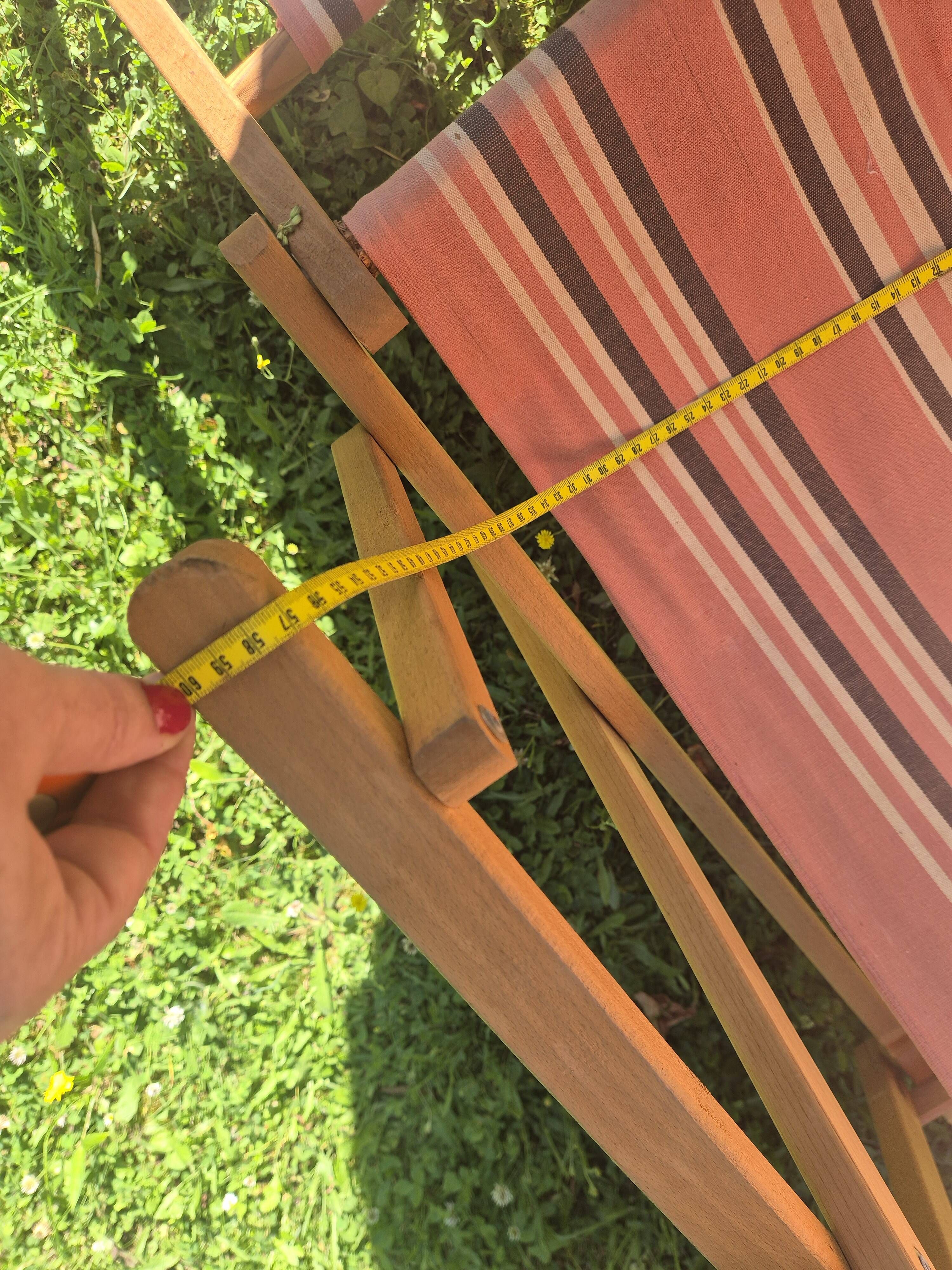 vintage wooden deck chair with striped fabric and footrest
