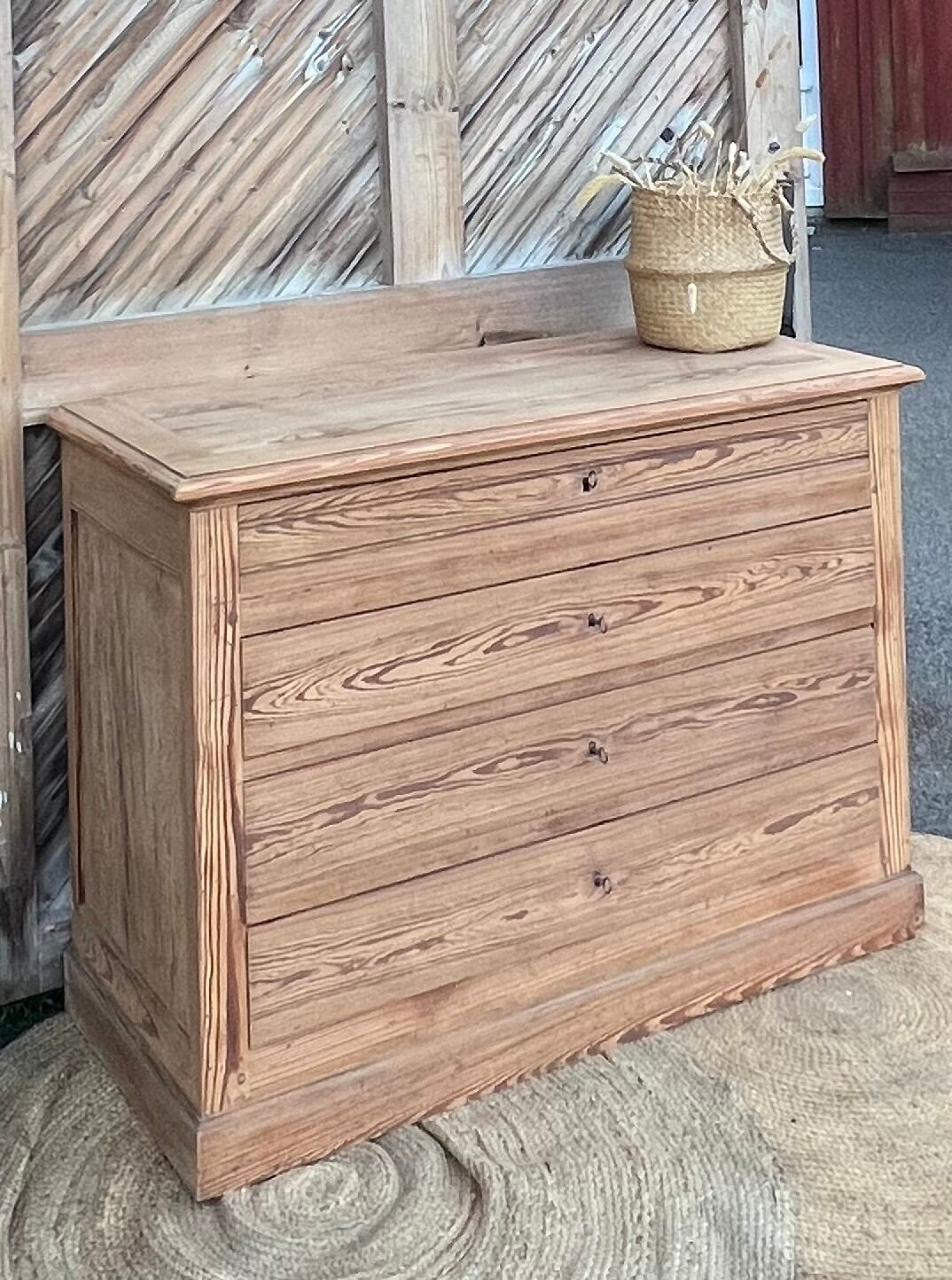 Large antique chest of drawers in raw solid wood.