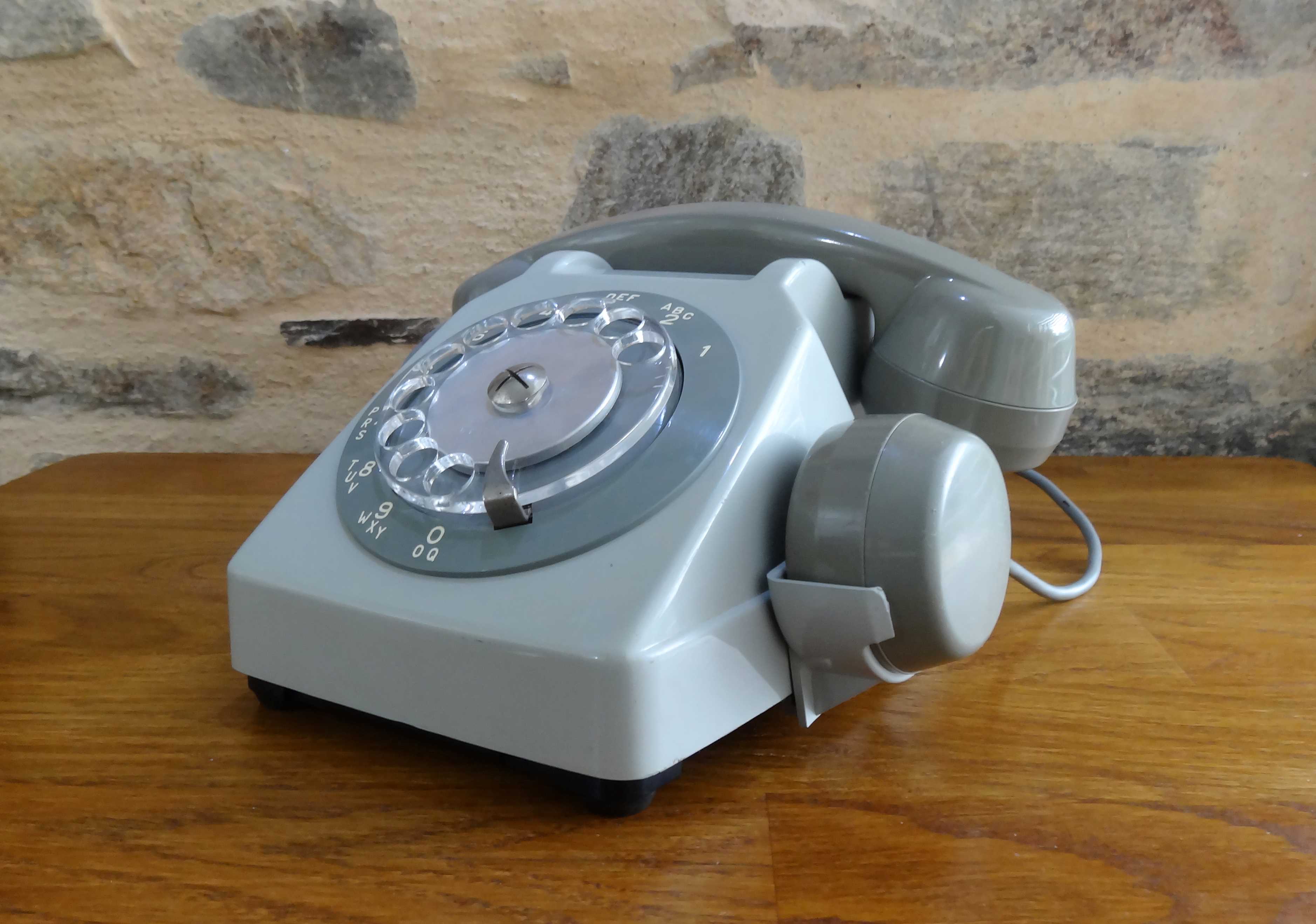 Grey vintage rotary dial phone with earpiece