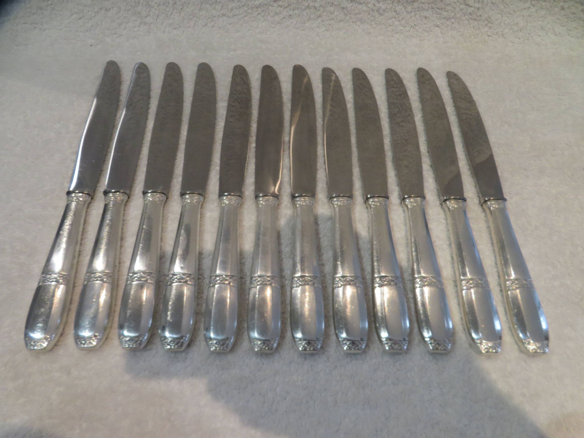 12 silver plated table knives by Argit goldsmith? Art Deco floral bands