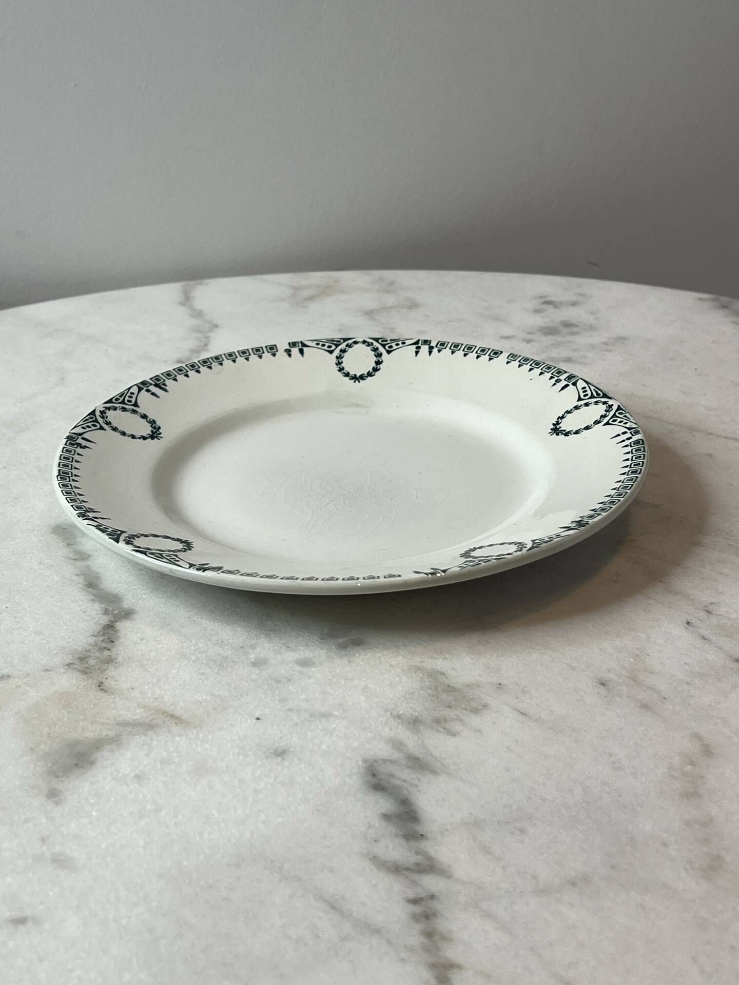 Set of 2 Saint Amand plates with laurel crown decoration.