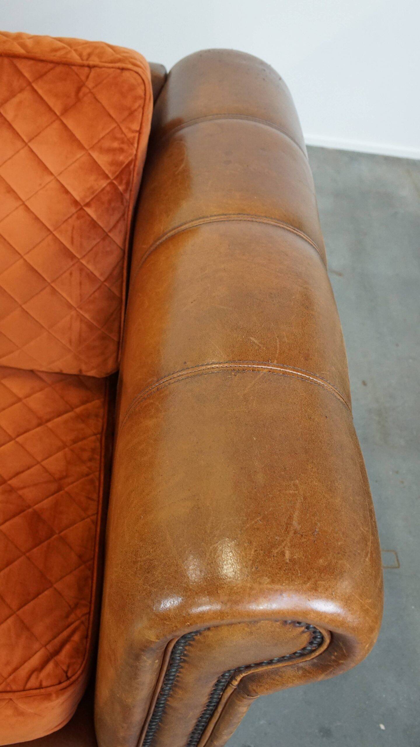 Luxury and comfortable sheepskin 2.5-seater sofa of top quality with orange fabric seat and back cushions