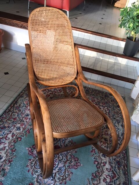 Rocking-chair with cane seating and backrest.
