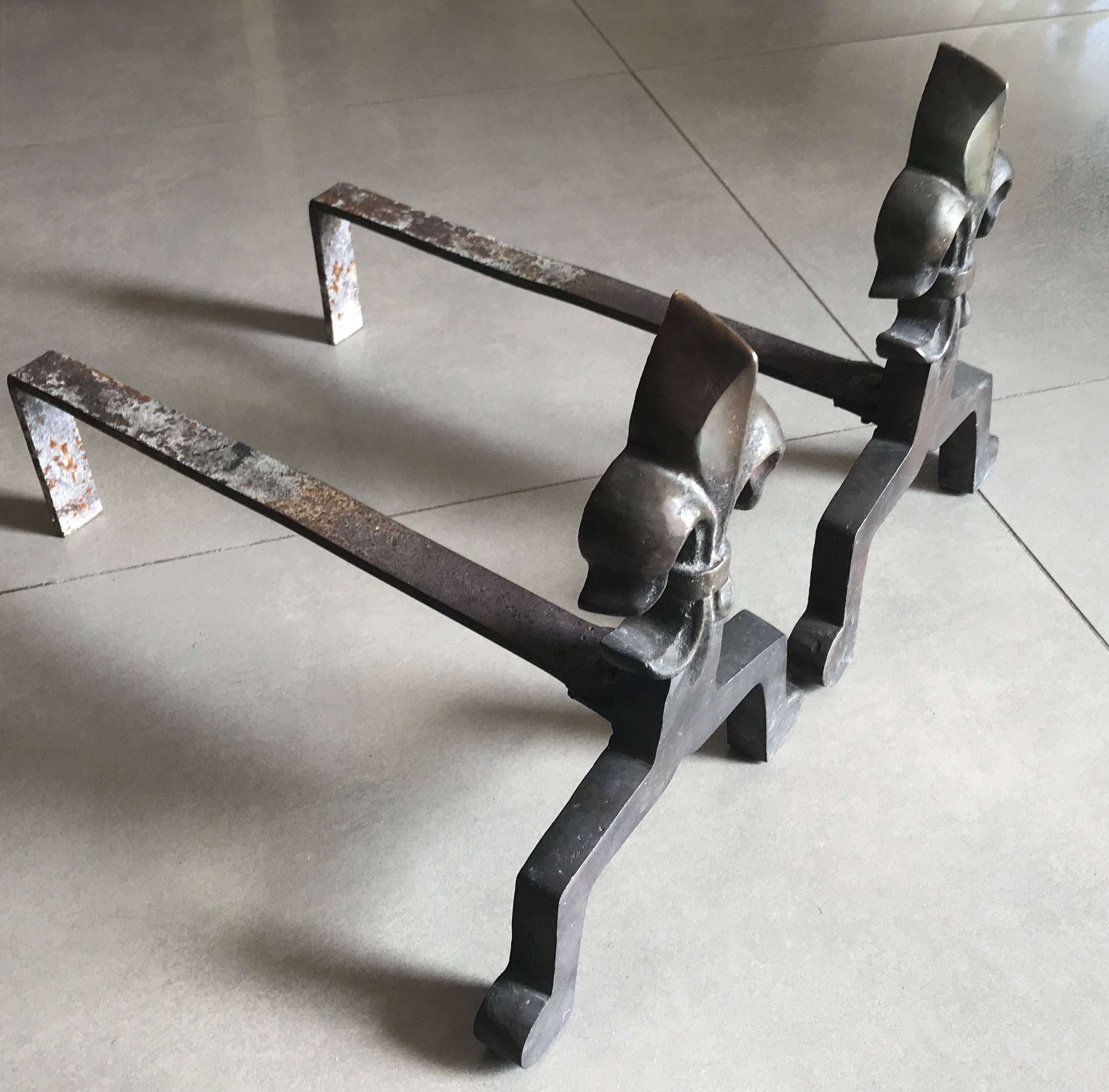 Pair of bronze fireplace firedogs with fleur-de-lys decor, art deco