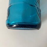 Blue glass bottle with embossed patterns at the bottom. Selters brand.
