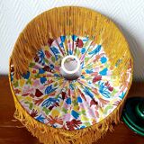 Green ceramic lamp with a vintage pleated fringe shade.