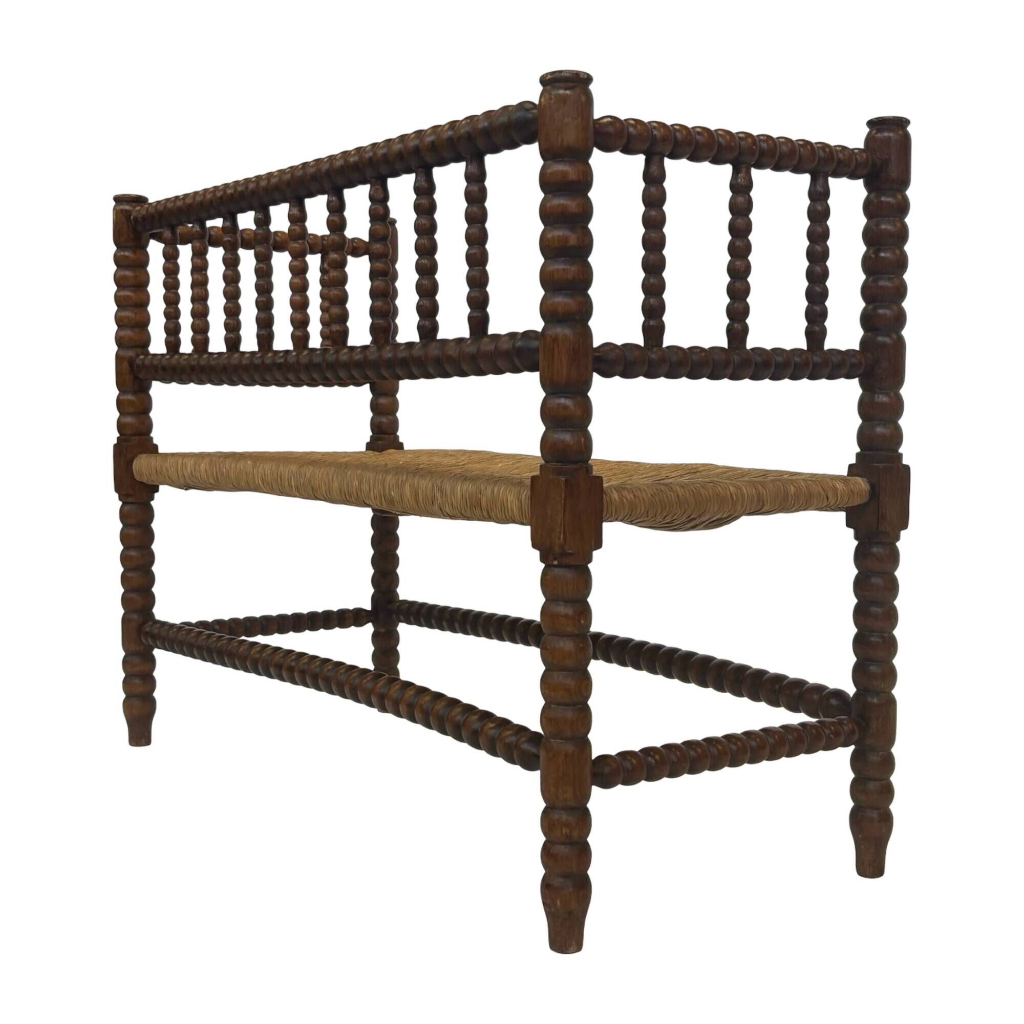 Vintage 'bobbin' bench with a rush seat, 1920s design with armrests.