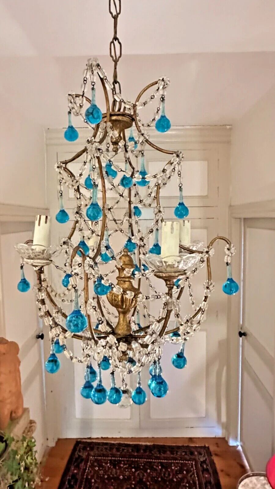 Italian chandelier with blue beads and gilded wood.