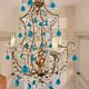 Italian chandelier with blue beads and gilded wood.