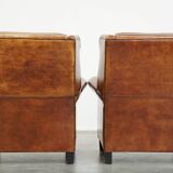 Set of 2 very comfortable large sheepskin armchairs elegantly finished with black piping