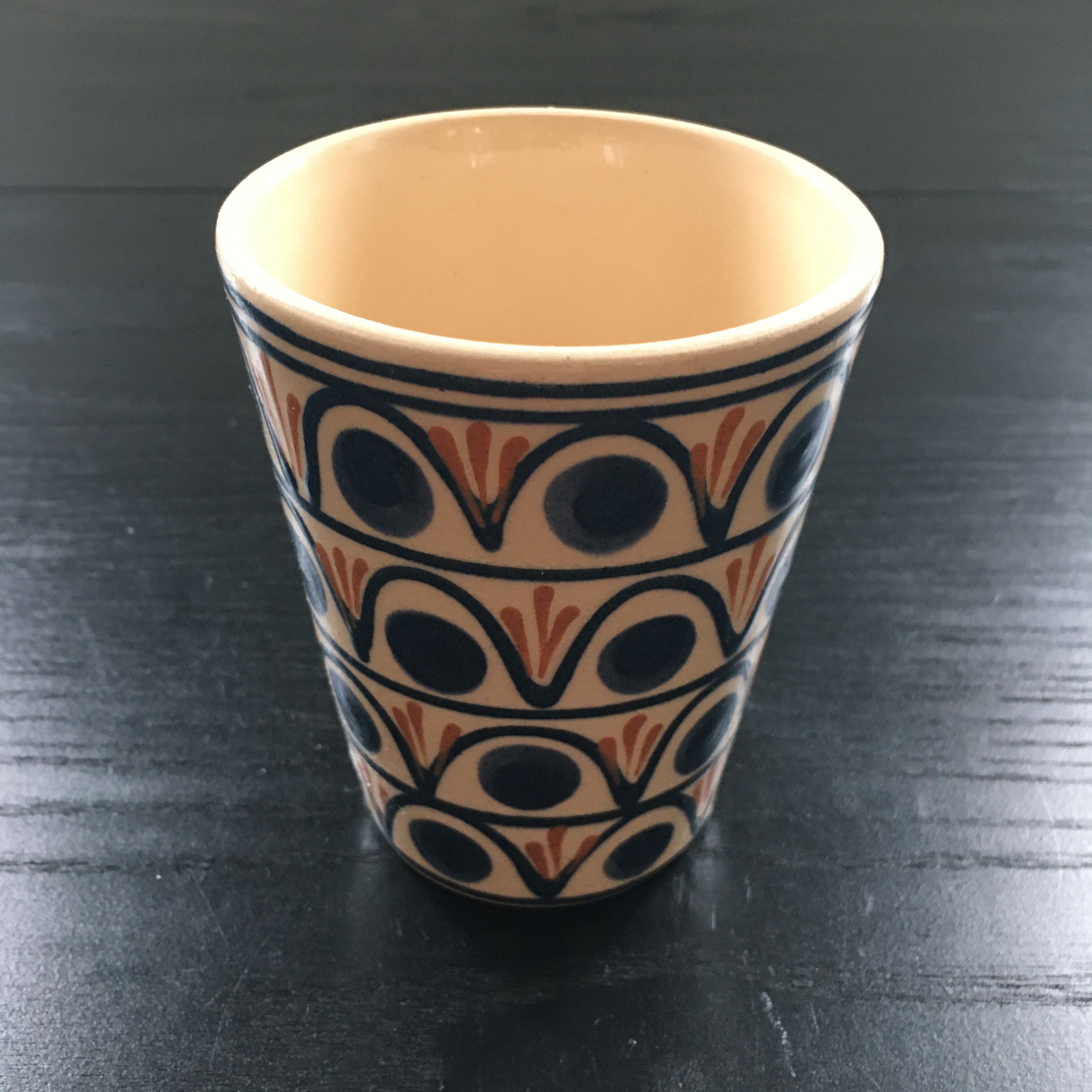 Ceramic cup with a signed decoration