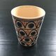 Ceramic cup with a signed decoration