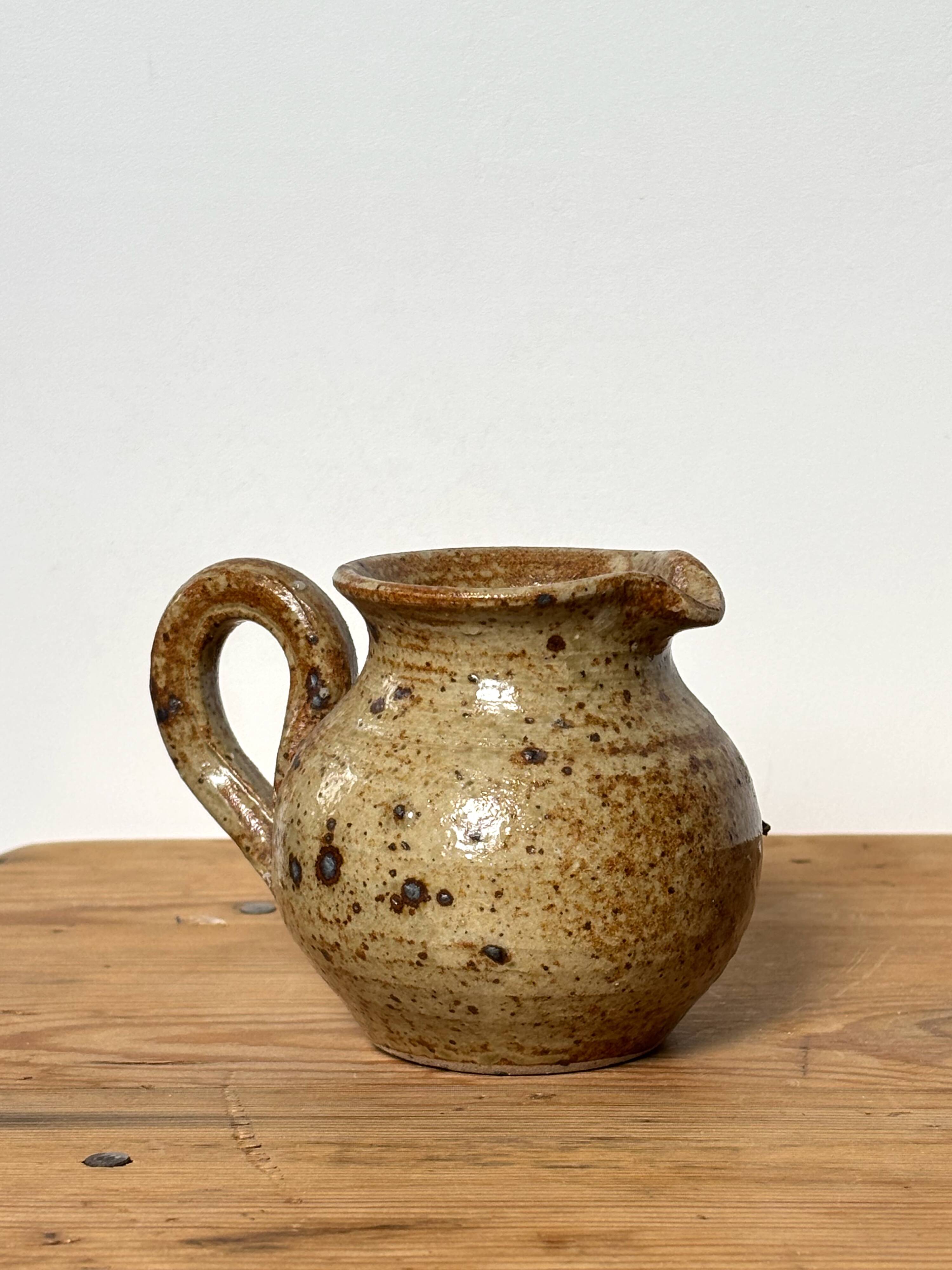Small beige speckled stoneware pitcher