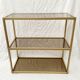 Golden metal shelf and smoked glass