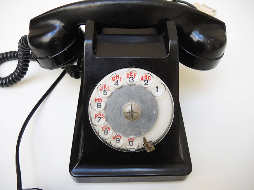 Old ptt phone with rotary dial in black bakelite