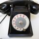 Old ptt phone with rotary dial in black bakelite