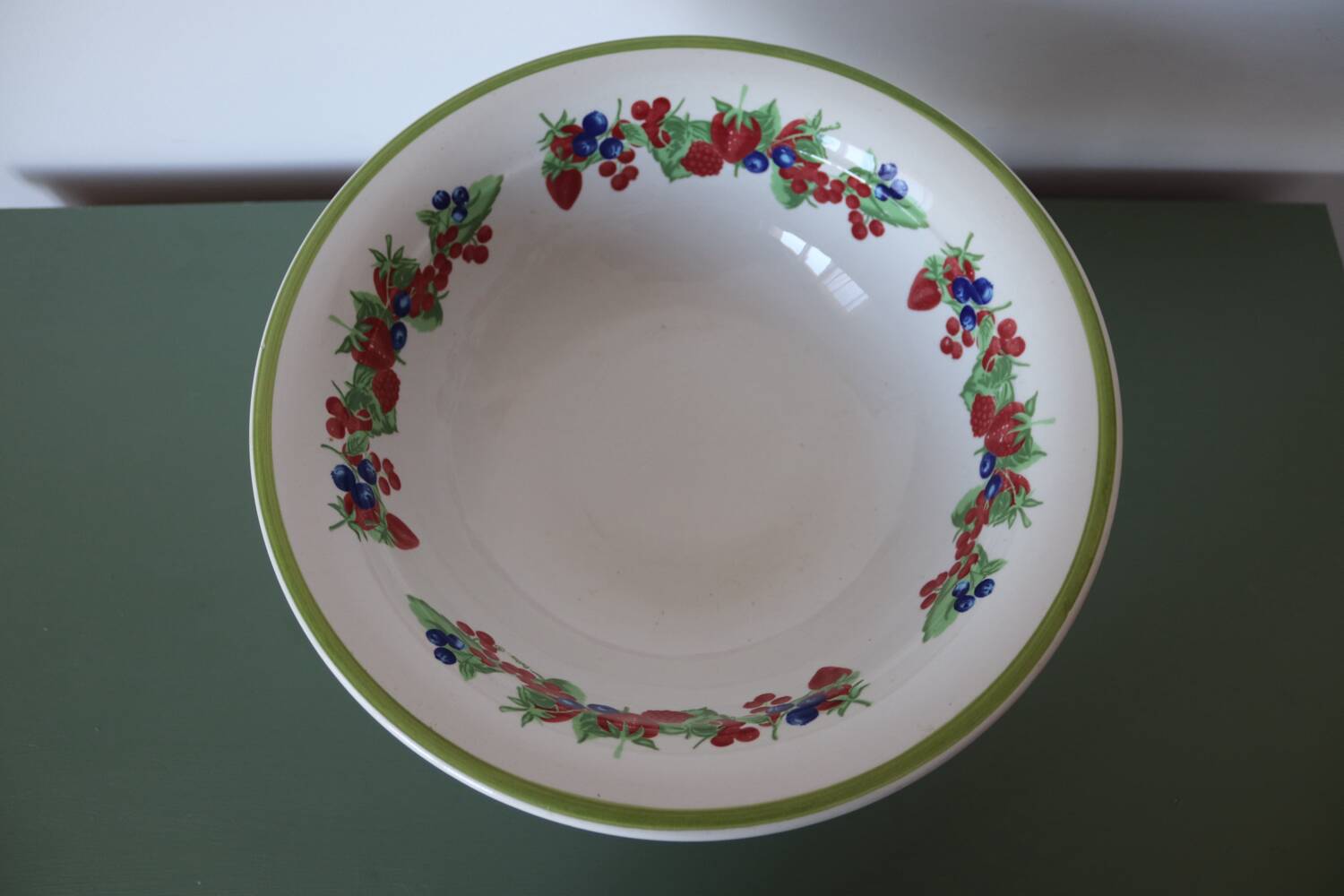 Large ceramic fruit bowl with red fruits
