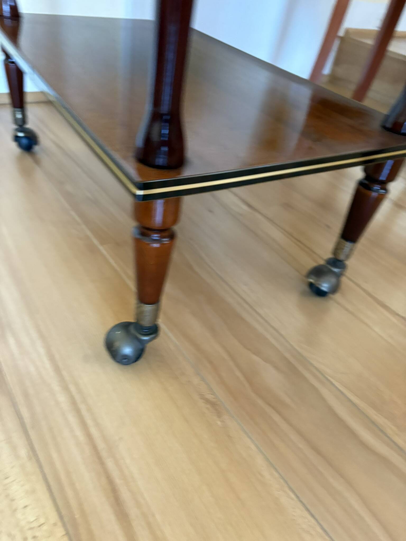 Table d’appoint vintage en bois verni, à roulettes et filets dorés