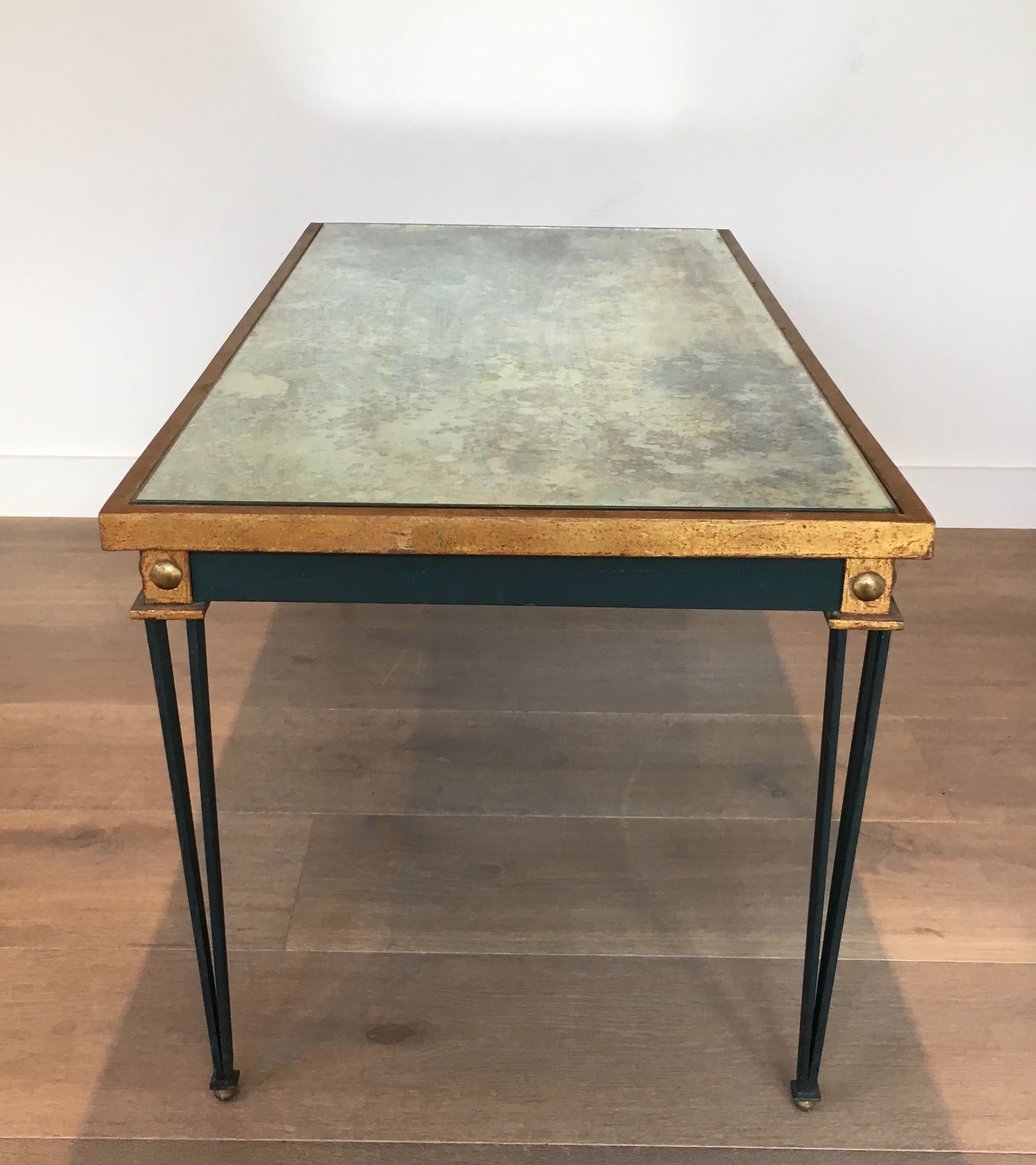 Patinated and gilded steel coffee table in the style of Jacques Quinet.