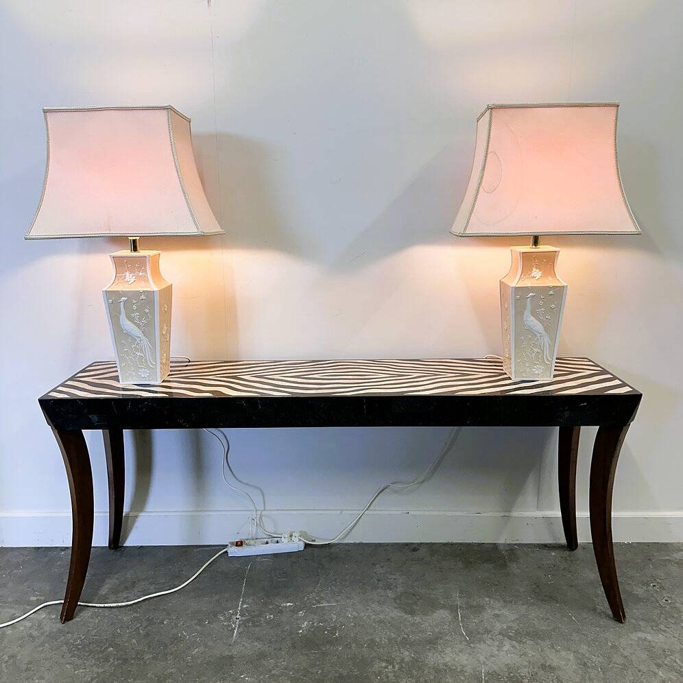 Pair of large cream ceramic table lamps with relief peacocks and fabric shades