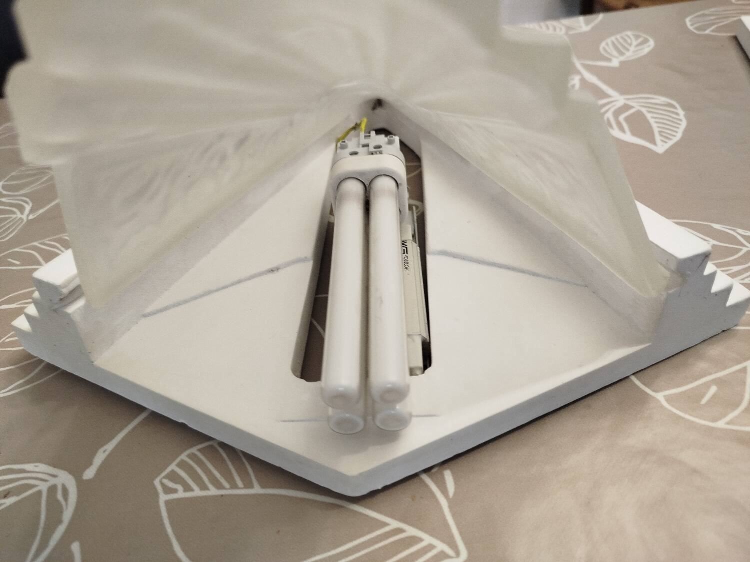 Pair of Art Deco wall sconces in plaster and pressed glass.