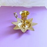 Golden brass hand candle holder decorated with leaves