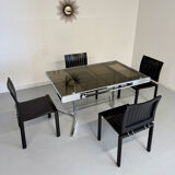 Smoked glass dining table with chrome legs, 1970s design by Roche Bobois.